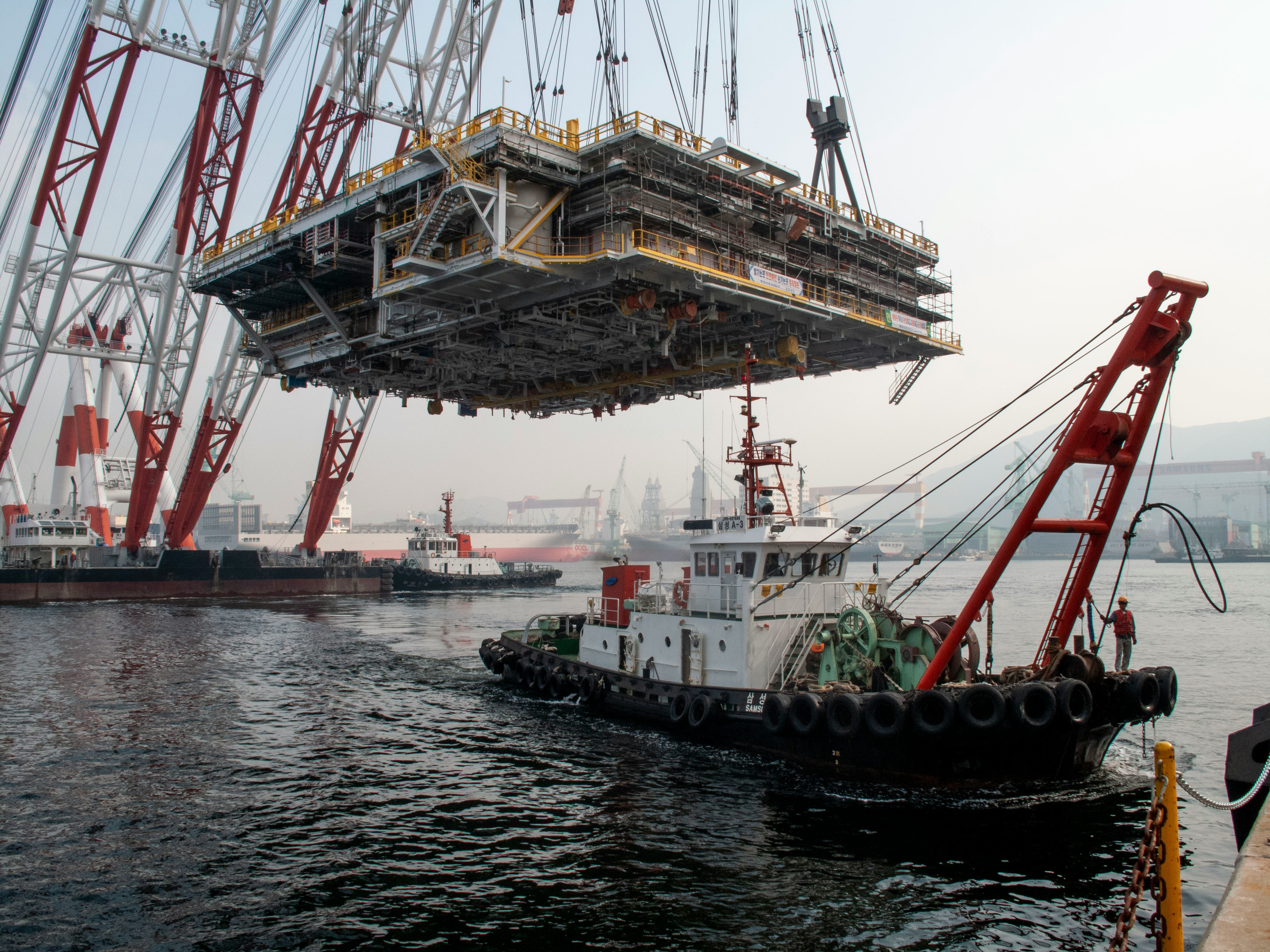 A mega block is suspended by the heavy lift barge in samsung heavy industries shipyard in south korea.